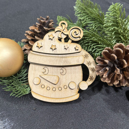 Wooden snowman ornament with decorative elements on a dark background with greenery and pine cones.