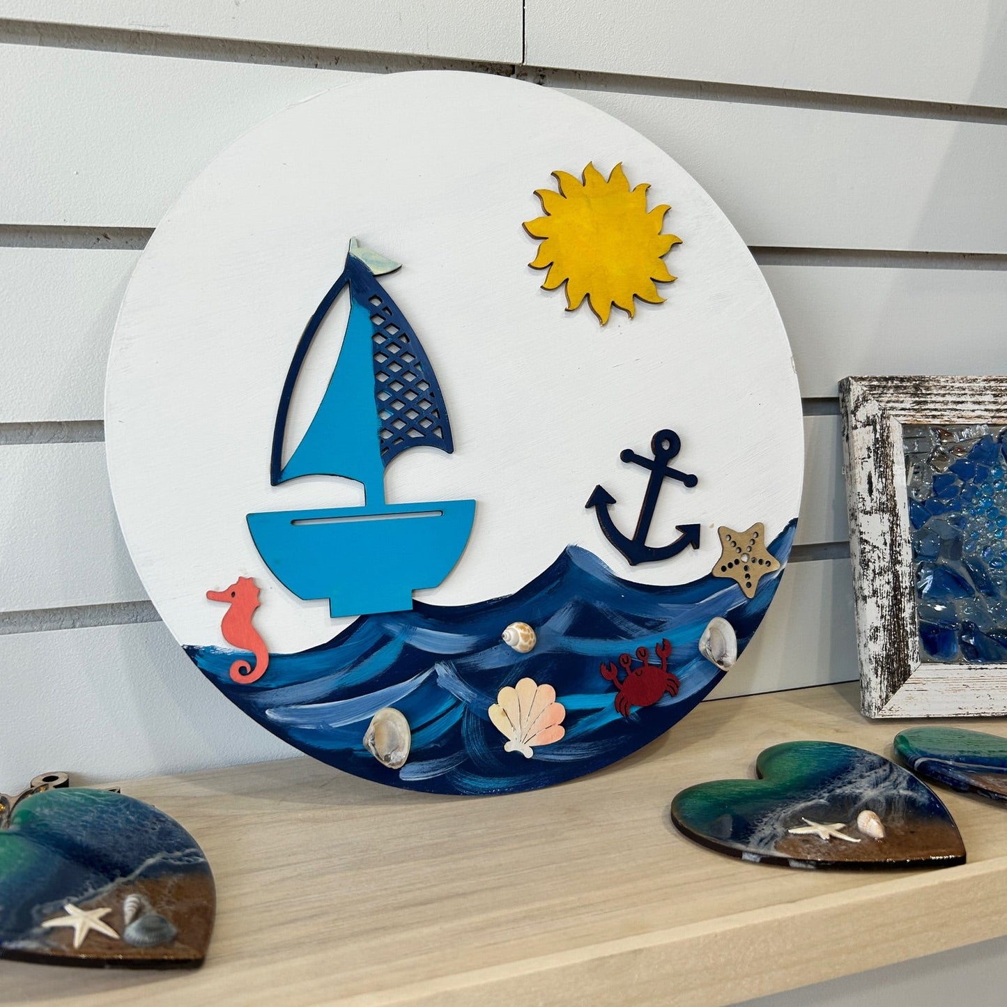 Decorative wall art with nautical elements on a wooden surface
