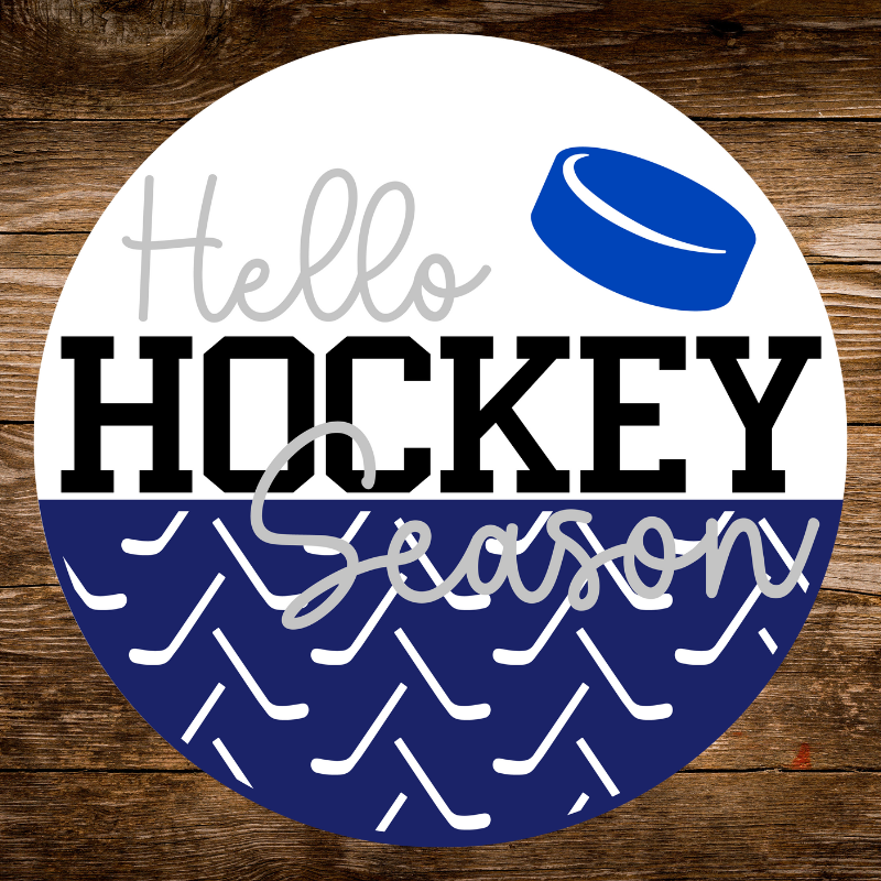 Circular sign with 'Hello Hockey Season' text on a wooden background