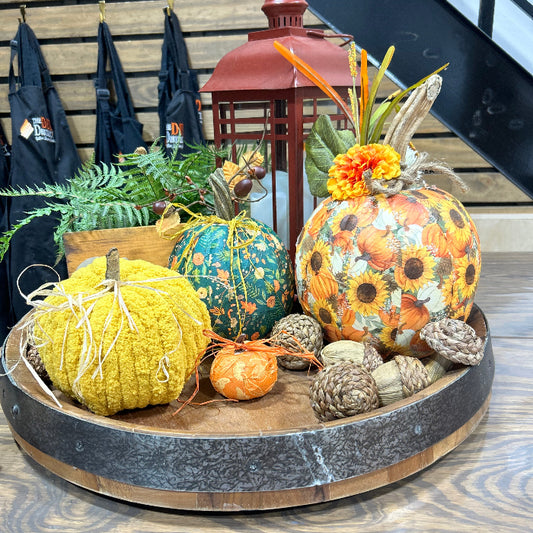 Decorative arrangement of pumpkins on a wooden surface with a blurred background.