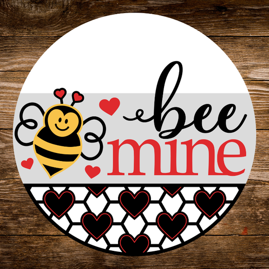 Round sign with a bee and 'bee mine' text on a wooden background