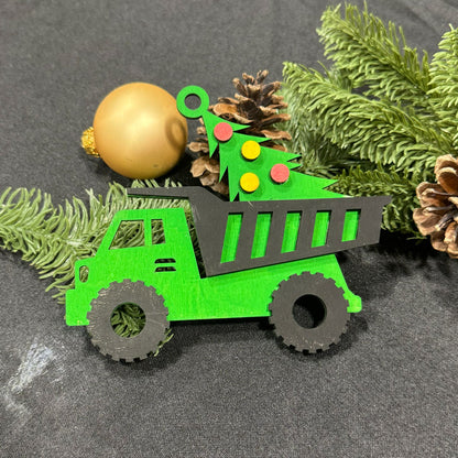 Green toy dump truck with Christmas decorations on a gray surface
