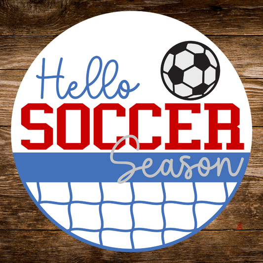 Circular sign with 'Hello Soccer Season' text and soccer ball on a wooden background