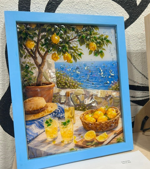 Framed artwork with a lemon theme, including a lemon tree and a table with lemons.