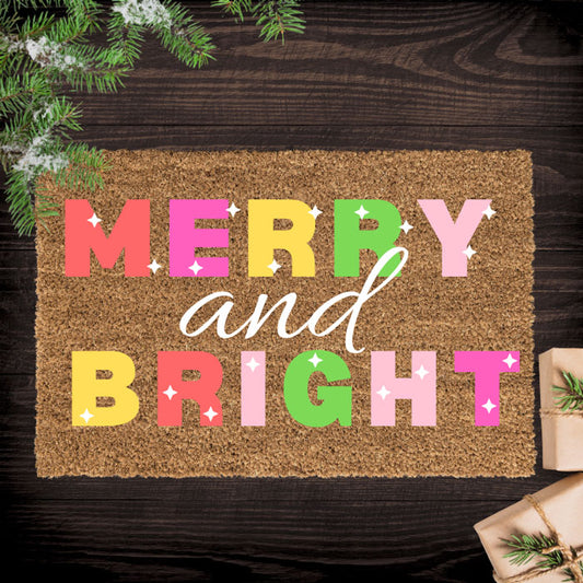 Doormat with 'Merry and Bright' text on a wooden floor with Christmas decorations.
