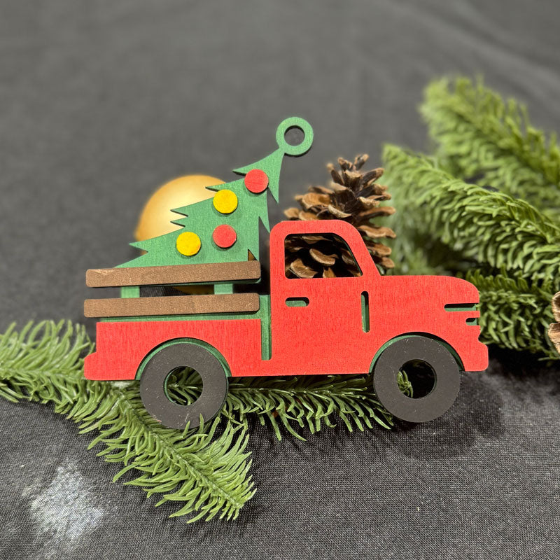 Red toy truck with a Christmas tree on a gray background