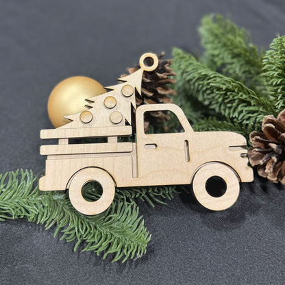 Wooden Christmas truck ornament with tree and ball on a dark background