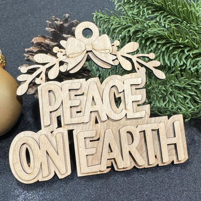 Wooden ornament with 'PEACE ON EARTH' text on a blue fabric background with greenery.