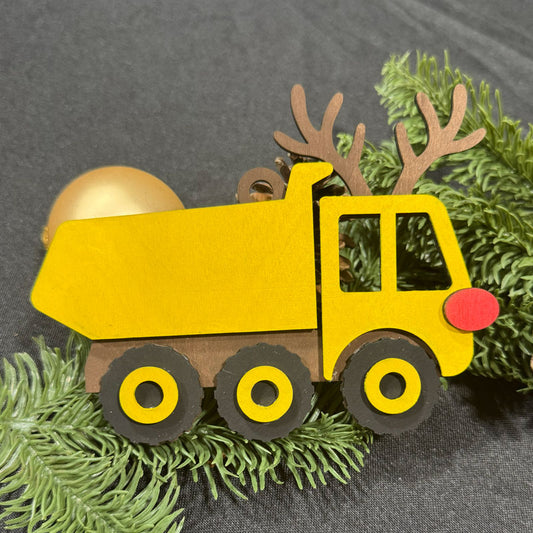 Yellow toy truck with reindeer antlers on a green wreath against a gray background