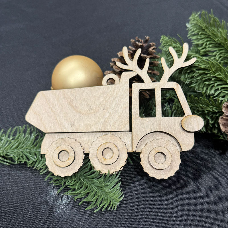 Wooden truck ornament with antlers and pinecones on a dark background