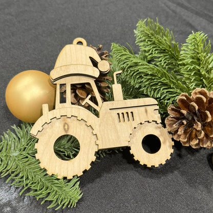 Wooden tractor ornament with pine branches and pinecones on a dark surface