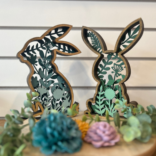 Decorative wooden bunny shapes with leaf patterns on a white background