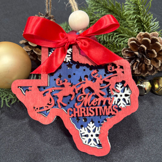Red Christmas ornament with reindeer and 'Merry Christmas' text, tied with a red ribbon, on a dark background.