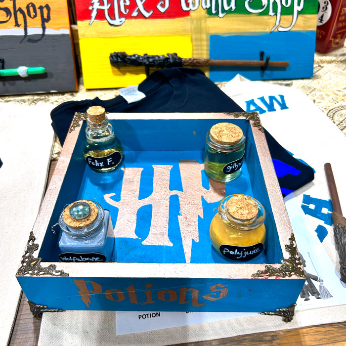 Harry Potter box with potions jars on table.